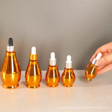 Pedidos de ouro do petróleo essencial cosmético garrafas giratórias de soro de ouro
